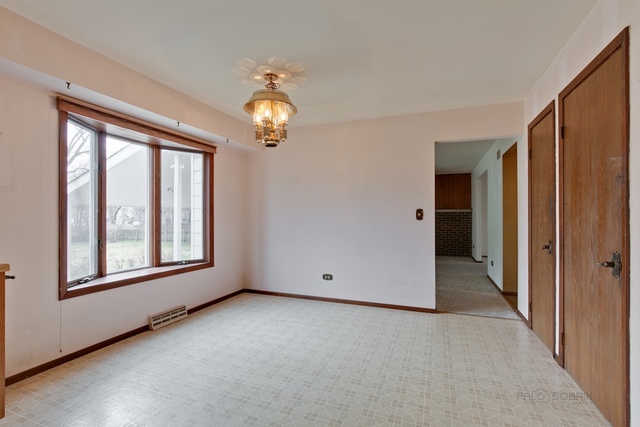 601 West Golf Road Libertyville, IL 60048 - Photo 10 of 27 an empty room with a window and chandelier