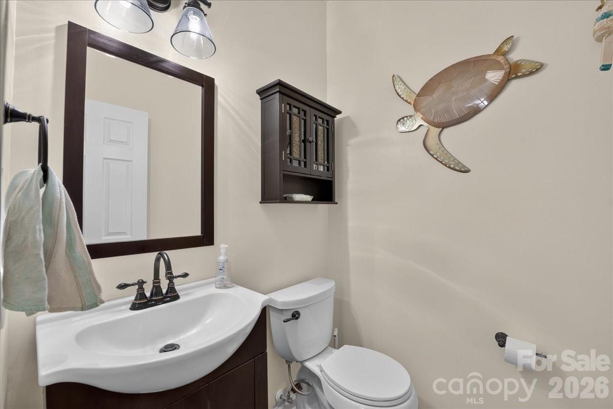 8006 Fine Robe Drive Indian Trail, NC 28079 - Photo 4 of 36 a bathroom with a sink a toilet and mirror
