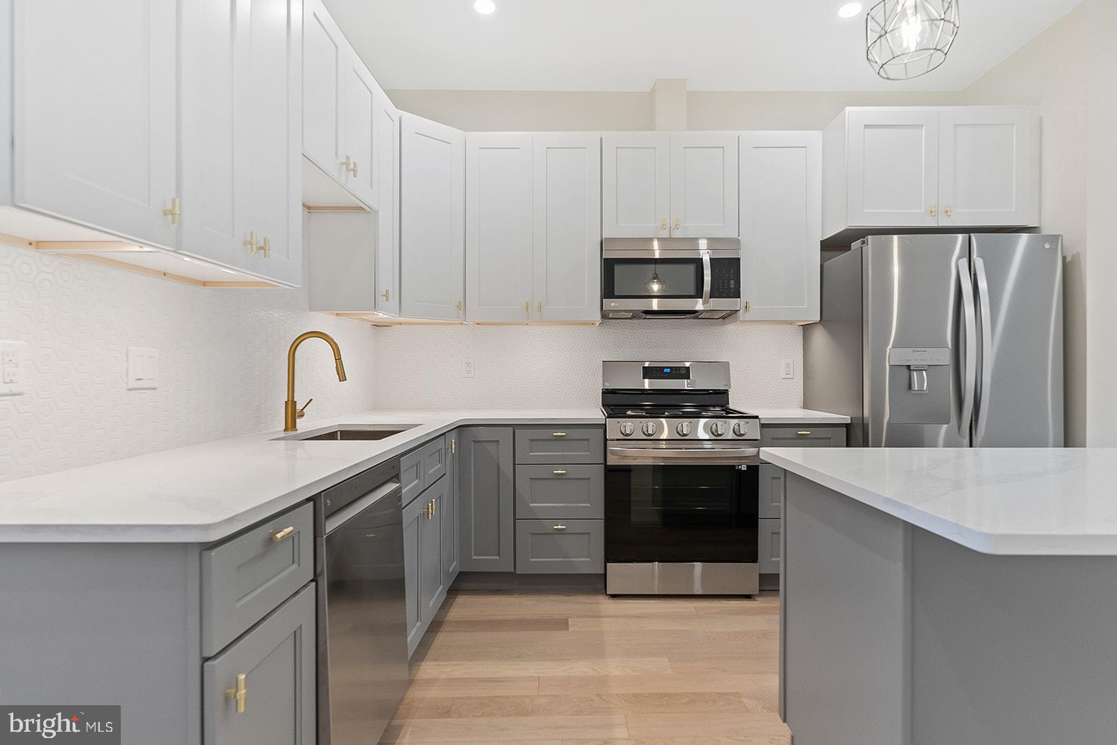 1644 North 6th Street Philadelphia, PA 19122 - Photo 14 of 52 a kitchen with stainless steel appliances a sink stove and refrigerator