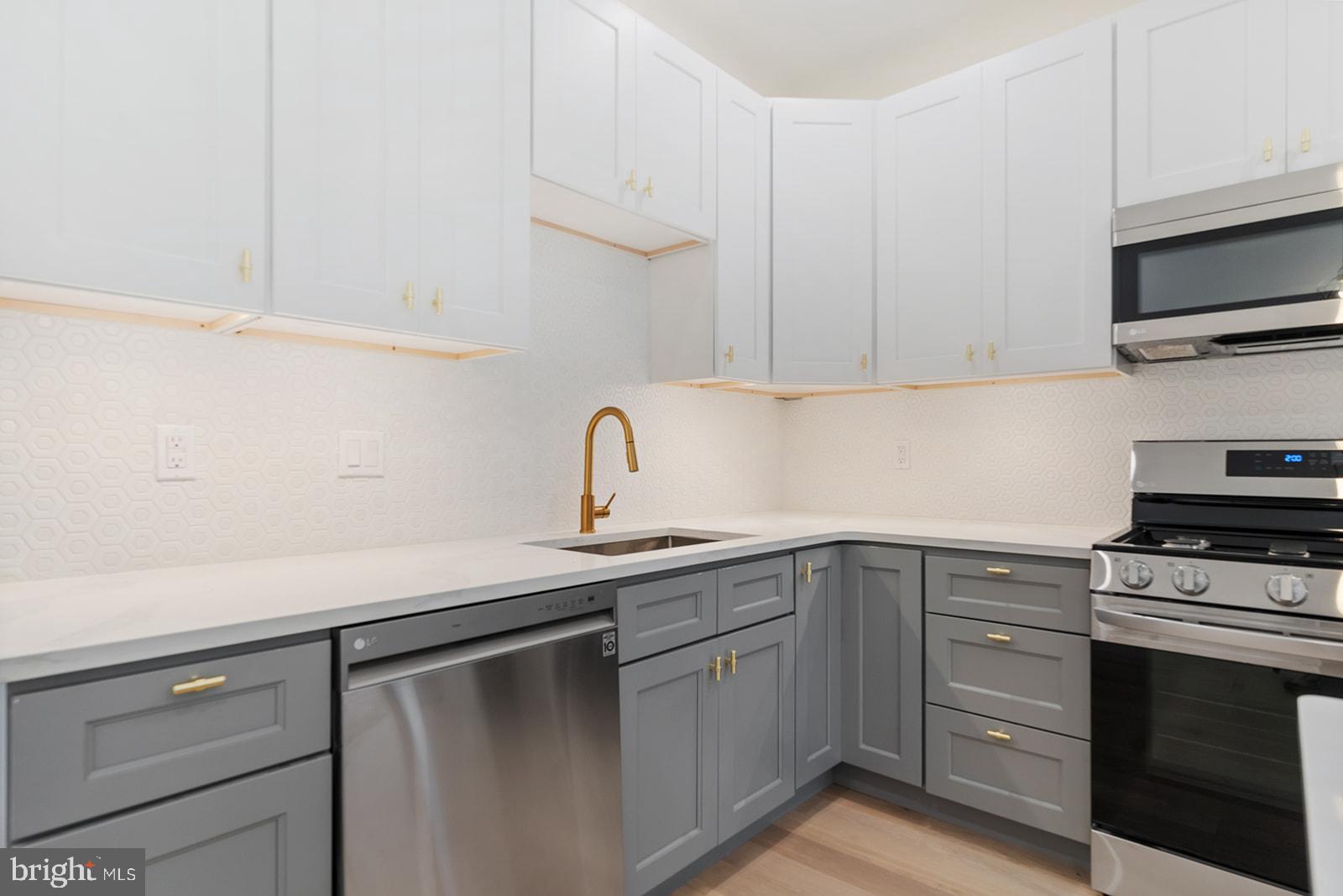 1644 North 6th Street Philadelphia, PA 19122 - Photo 15 of 52 a kitchen with cabinets appliances a sink and a counter top