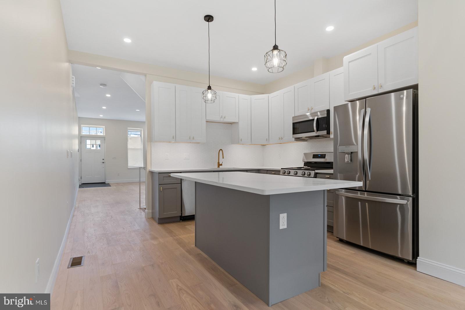 1644 North 6th Street Philadelphia, PA 19122 - Photo 17 of 52 a kitchen with kitchen island a sink stainless steel appliances and cabinets