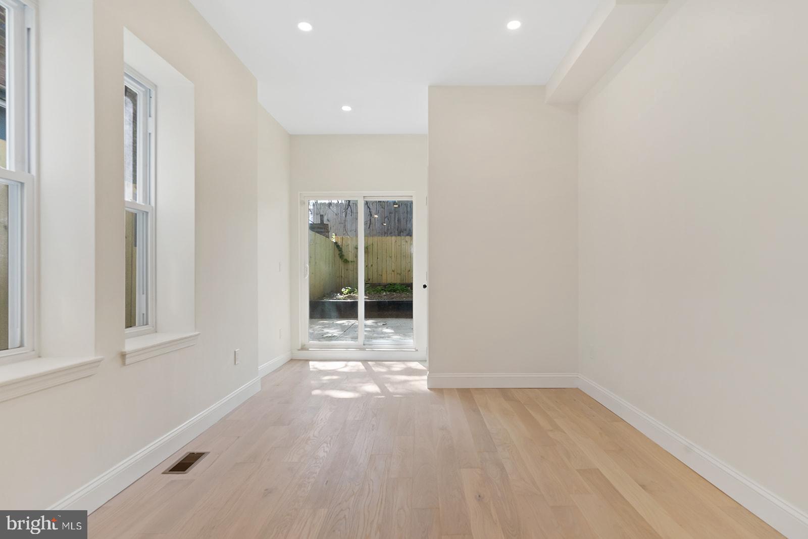 1644 North 6th Street Philadelphia, PA 19122 - Photo 18 of 52 an empty room with wooden floor and windows