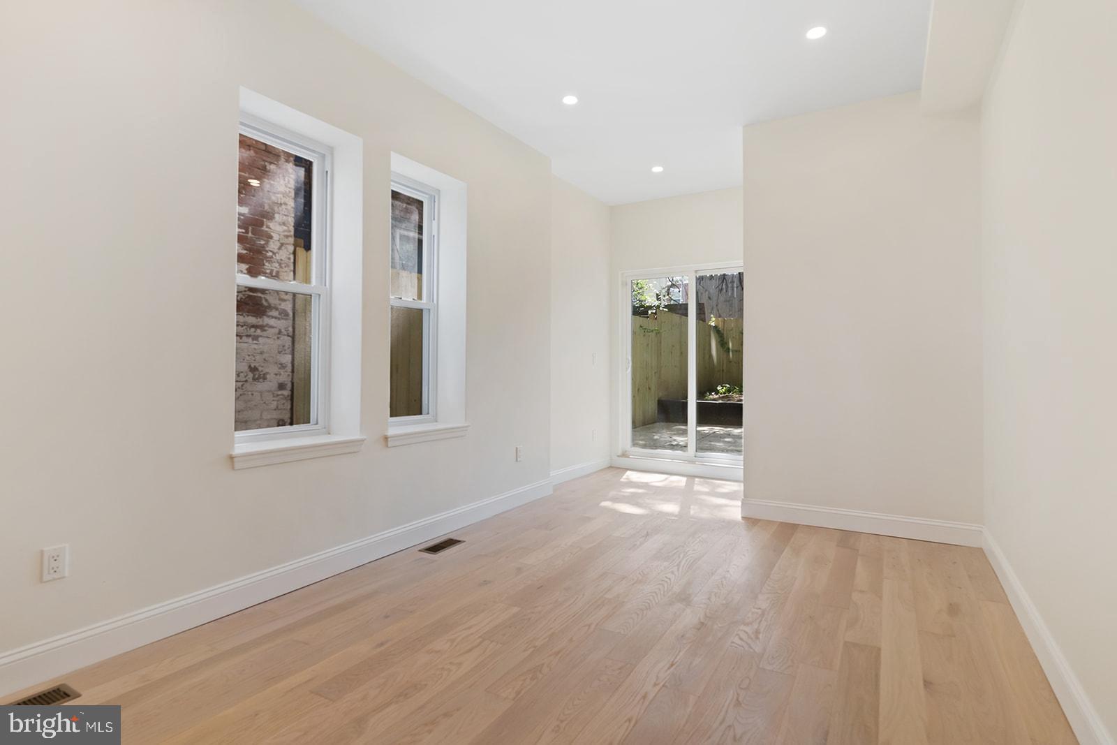 1644 North 6th Street Philadelphia, PA 19122 - Photo 19 of 52 an empty room with wooden floor and windows