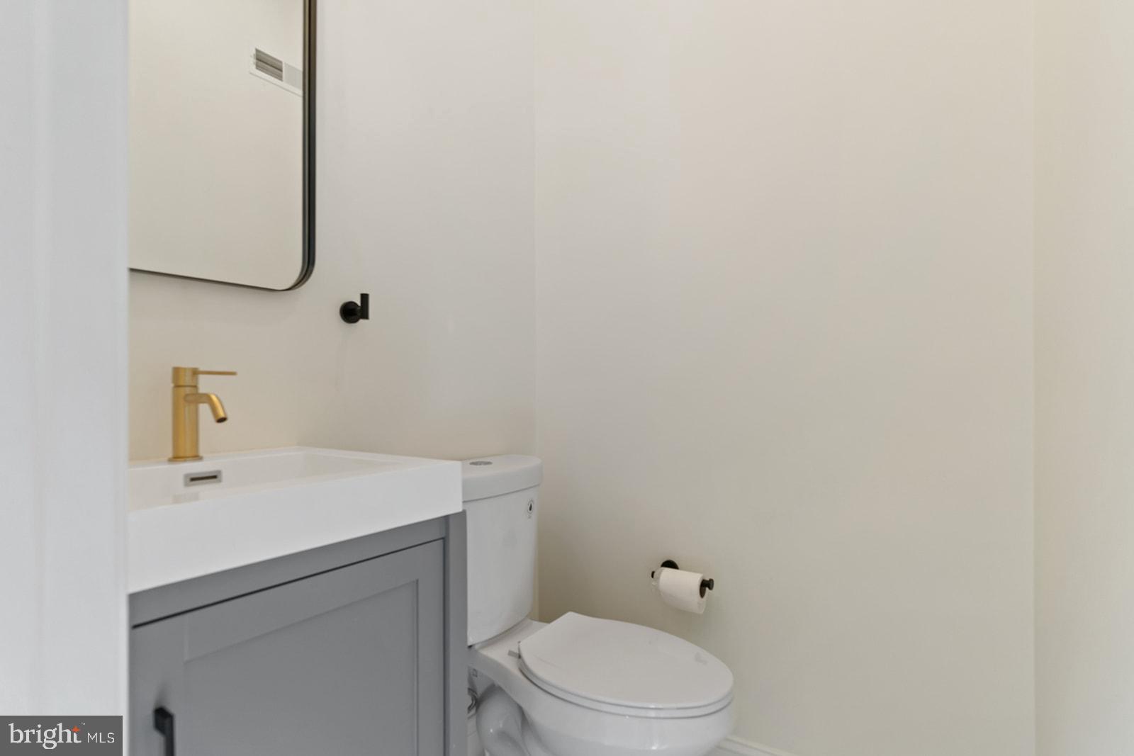 1644 North 6th Street Philadelphia, PA 19122 - Photo 23 of 52 a bathroom with a sink a toilet and mirror