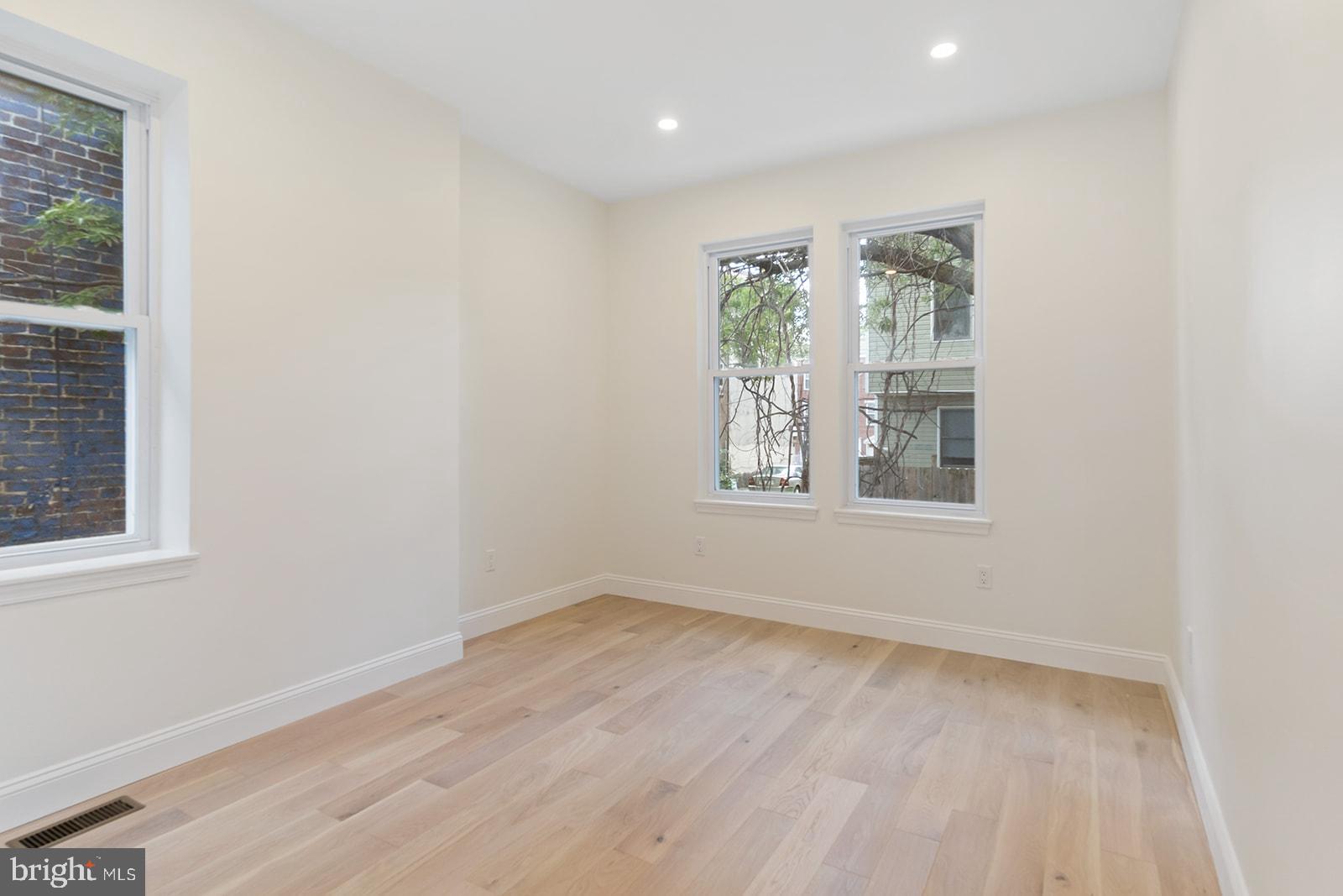 1644 North 6th Street Philadelphia, PA 19122 - Photo 31 of 52 an empty room with wooden floor and windows