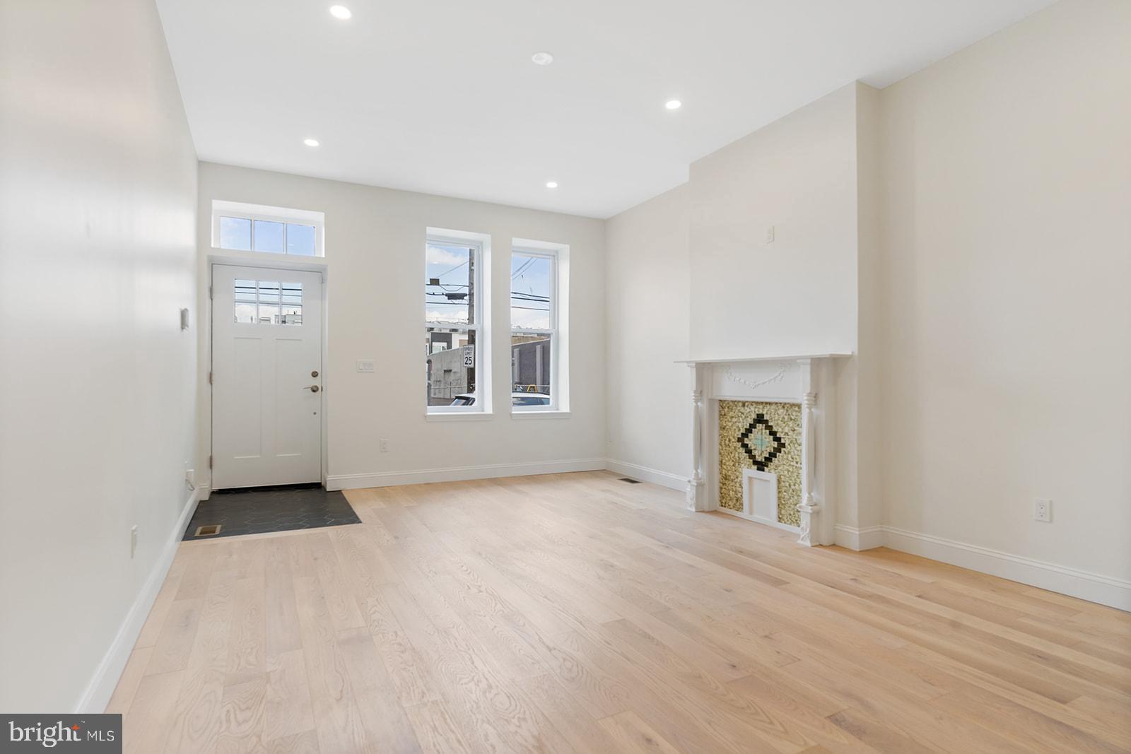 1644 North 6th Street Philadelphia, PA 19122 - Photo 4 of 52 an empty room with windows and a fireplace