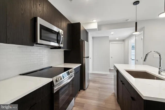 a kitchen that has a sink and a stove in it