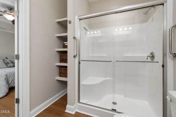 a bathroom with a glass shower door