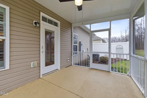 a view of a porch with a table and chairs