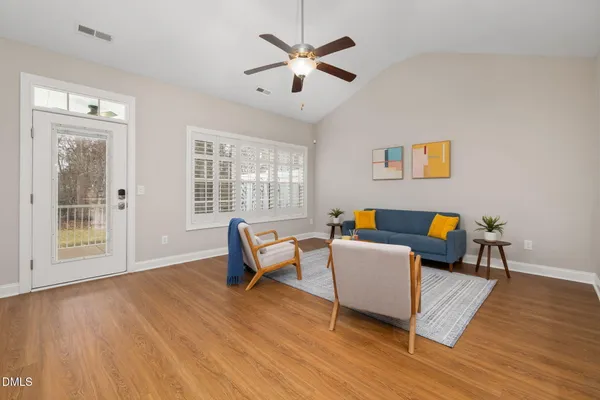 a living room with furniture and a wooden floor