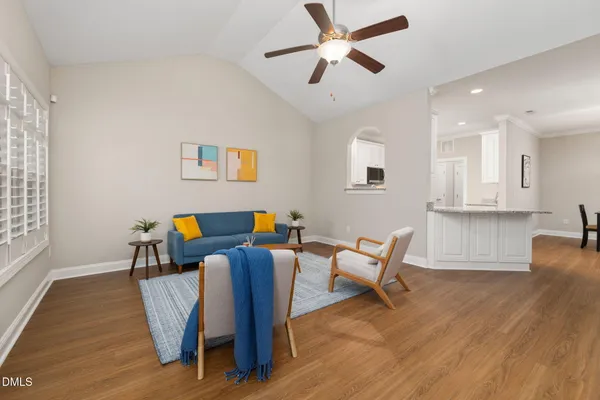 a living room with furniture pool table and a window