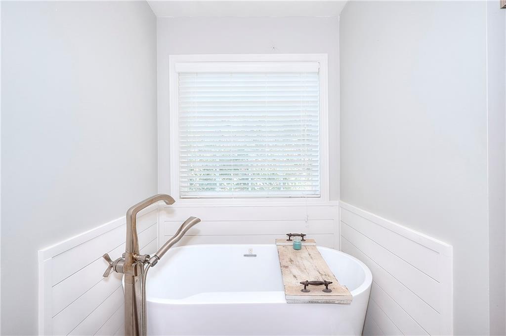 25 Browning Shoals Road Social Circle, GA 30025 - Photo 22 of 47 a white bath tub sitting next to a window