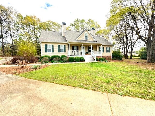 25 Browning Shoals Road Social Circle, GA 30025 - Photo 43 of 47 a front view of a house with a yard and potted plants