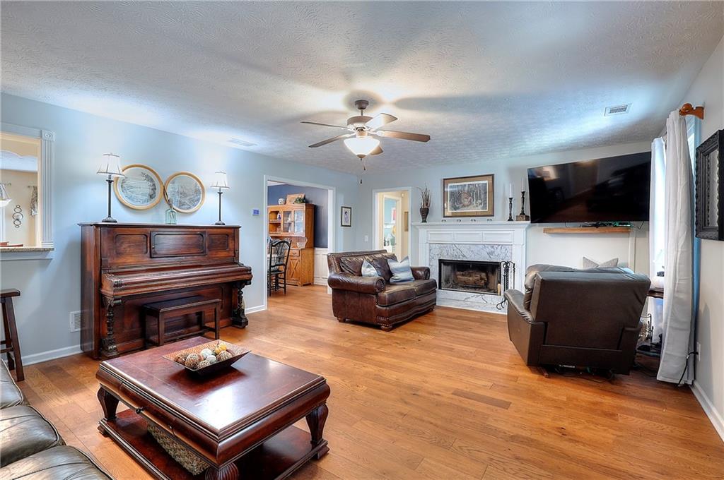 25 Browning Shoals Road Social Circle, GA 30025 - Photo 6 of 47 a living room with furniture a flat screen tv and a fireplace