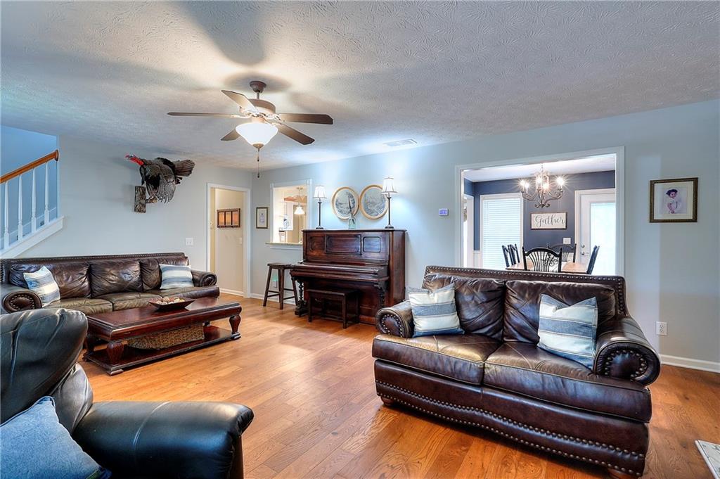25 Browning Shoals Road Social Circle, GA 30025 - Photo 7 of 47 a living room with furniture ceiling fan and a rug