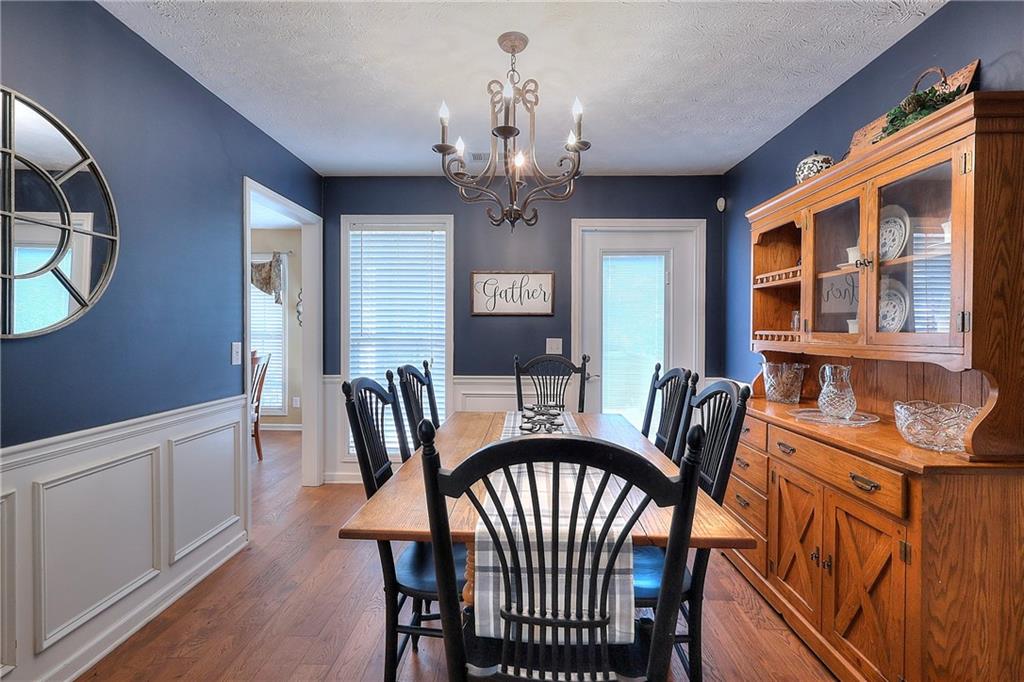 25 Browning Shoals Road Social Circle, GA 30025 - Photo 9 of 47 a view of a dining room with furniture chandelier and wooden floor