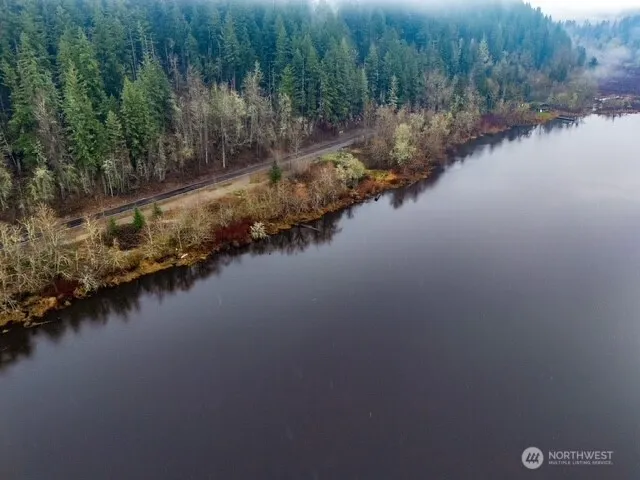 a view of a lake with trees all around