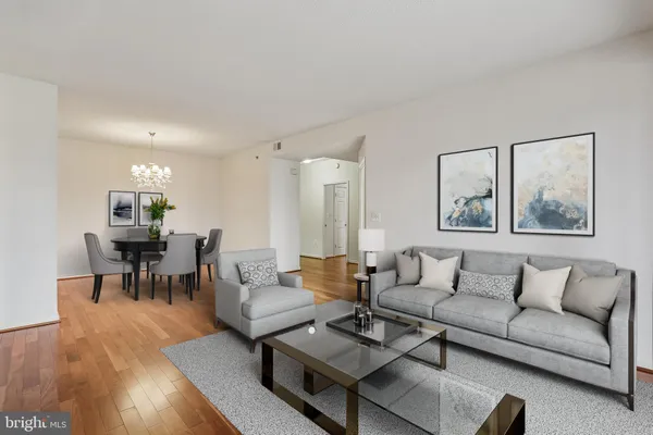 a living room with furniture wooden floor and dining table