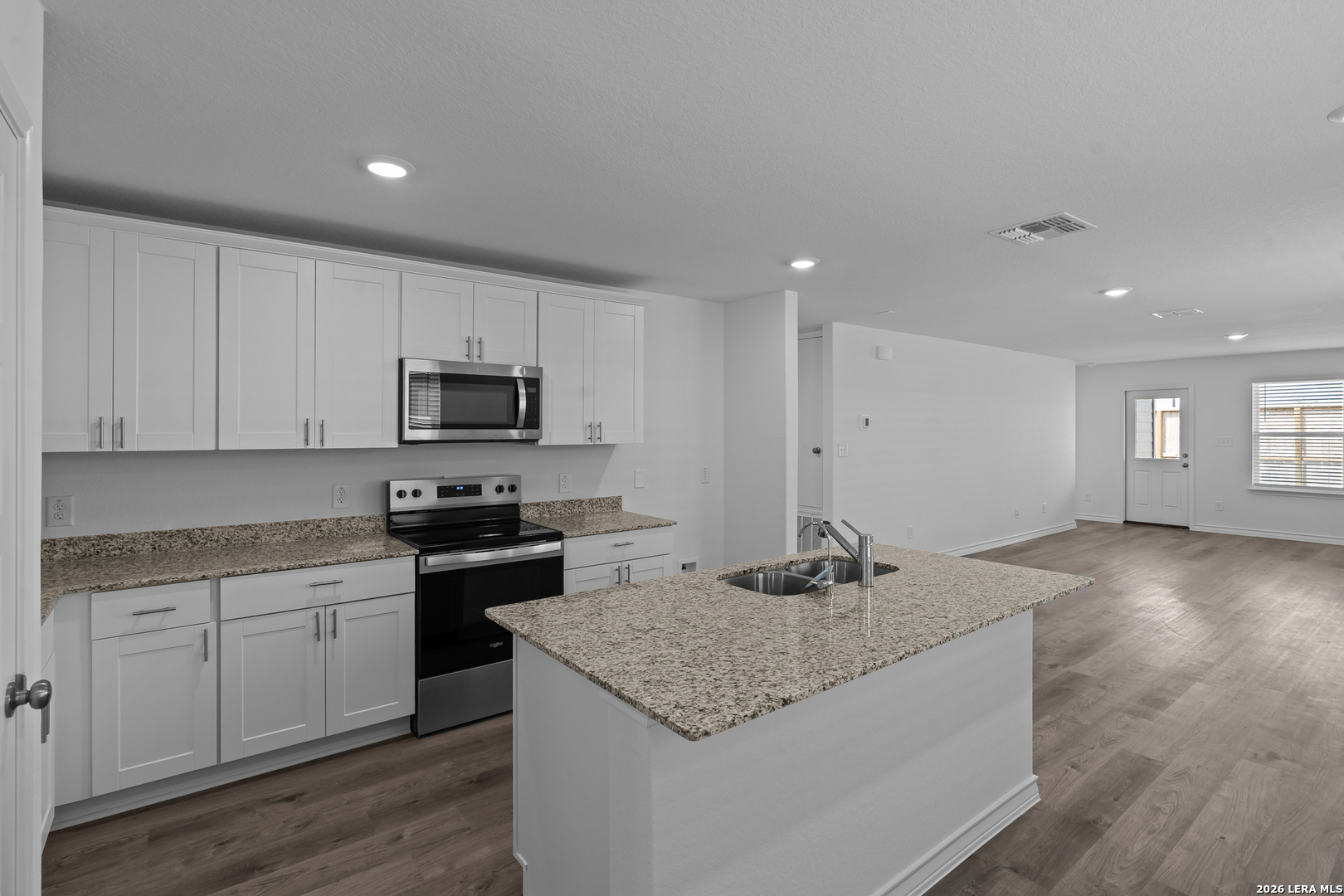 4061 Bermuda Lane Seguin, TX 78155 - Photo 3 of 25 a kitchen with granite countertop a stove top oven a sink a counter space and cabinets