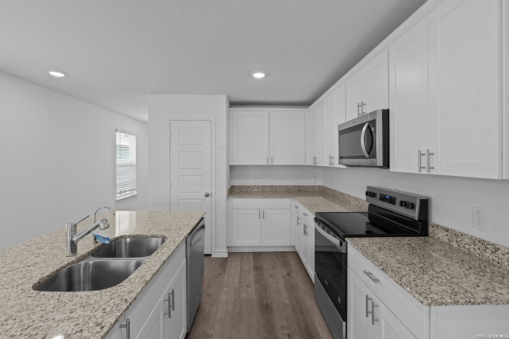 4061 Bermuda Lane Seguin, TX 78155 - Photo 5 of 25 a kitchen with granite countertop a sink a stove and cabinets