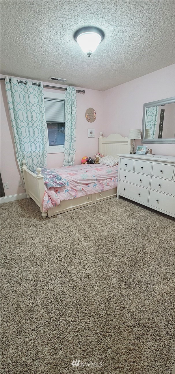 317 Grasseth Poston Road Longview, WA 98632 - Photo 16 of 36 a bedroom with a bed and a potted plant