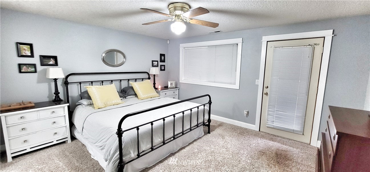 317 Grasseth Poston Road Longview, WA 98632 - Photo 17 of 36 a bedroom with a bed and a chandelier