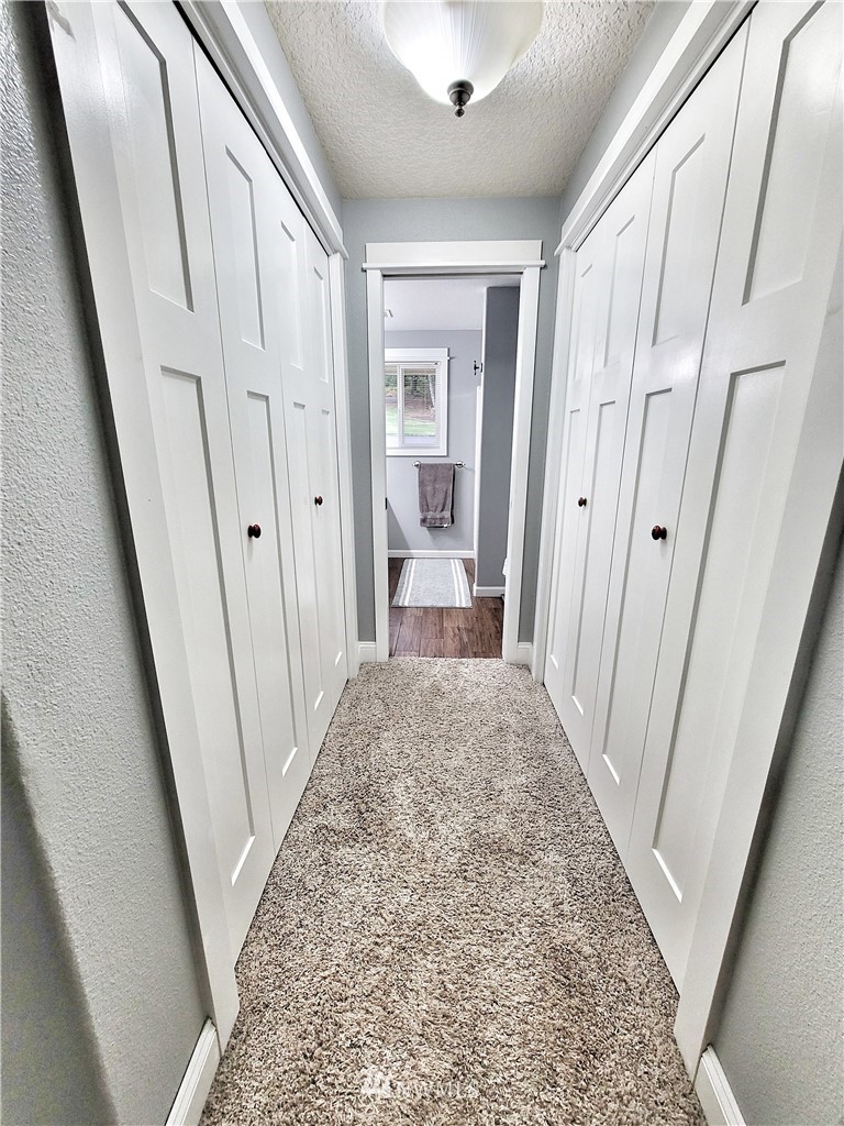 317 Grasseth Poston Road Longview, WA 98632 - Photo 18 of 36 a view of a hallway view with wooden floor and staircase