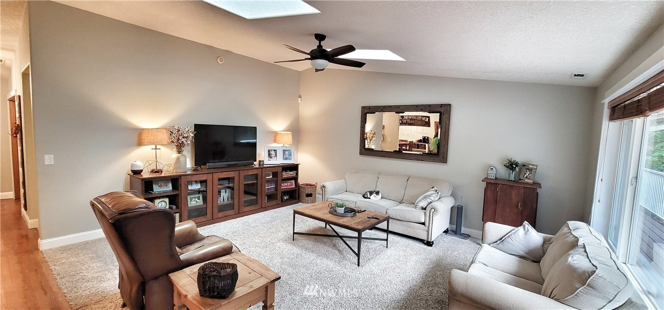 317 Grasseth Poston Road Longview, WA 98632 - Photo 5 of 36 a living room with furniture a flat screen tv and a window