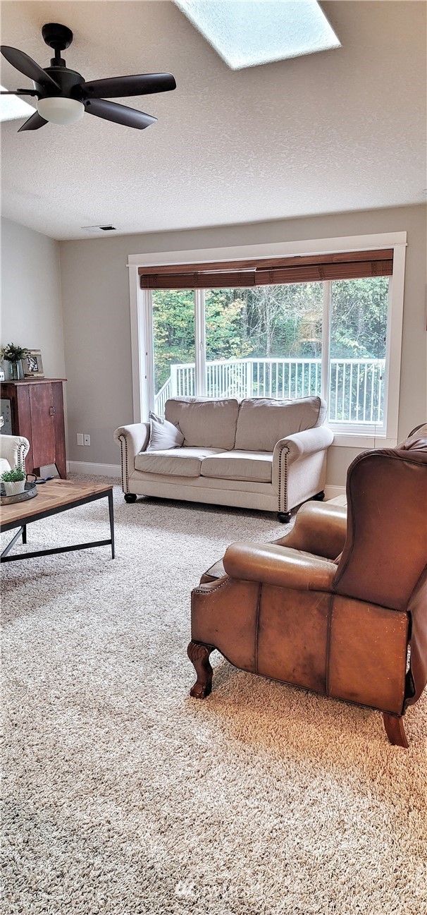317 Grasseth Poston Road Longview, WA 98632 - Photo 6 of 36 a living room with furniture and a floor to ceiling window