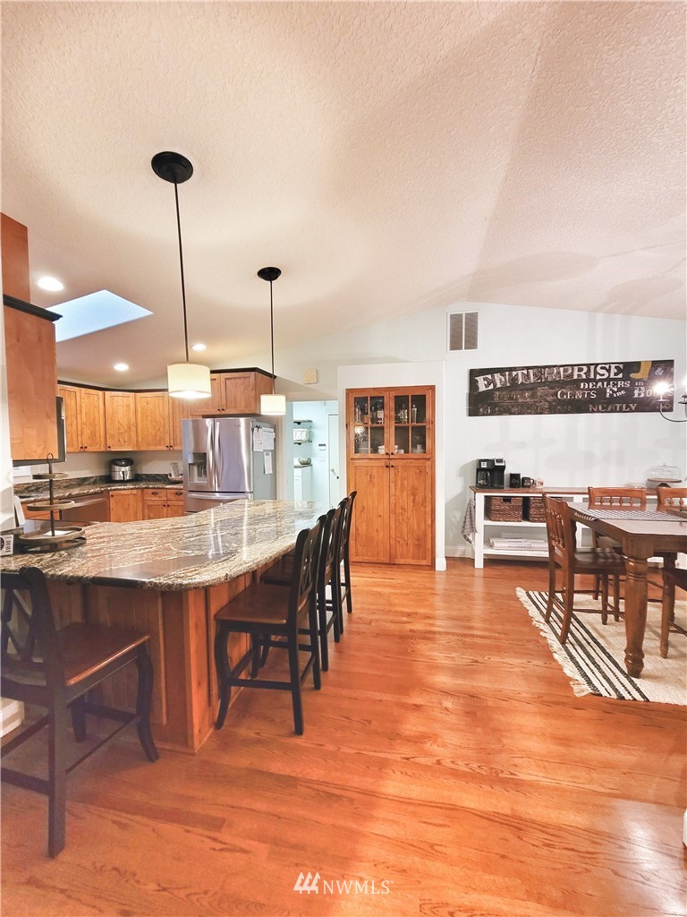 317 Grasseth Poston Road Longview, WA 98632 - Photo 9 of 36 a dining hall with stainless steel appliances granite countertop a stove and a kitchen island