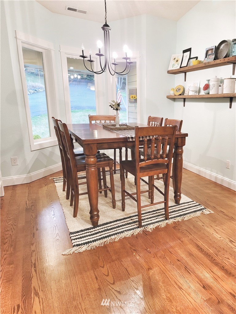 317 Grasseth Poston Road Longview, WA 98632 - Photo 10 of 36 a view of a dining room with furniture and wooden floor
