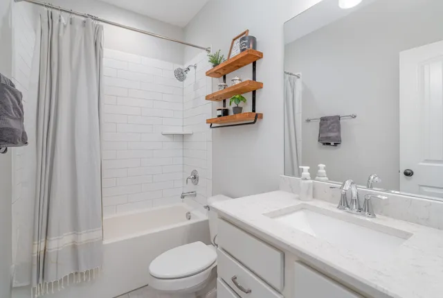 a bathroom with a sink a toilet and a bathtub