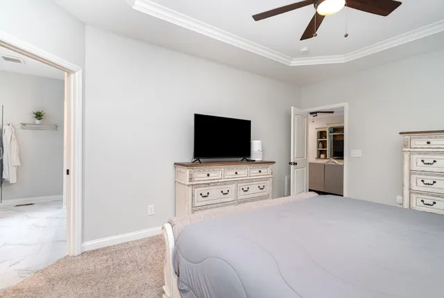 a bedroom with furniture and flat screen tv