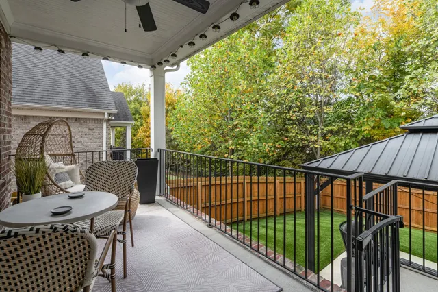 a view of a patio with a table and chairs