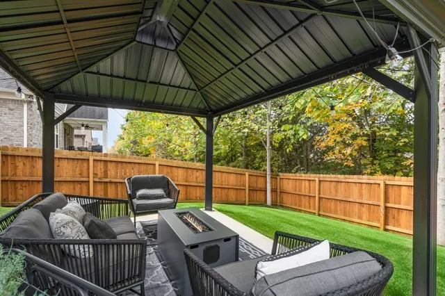 a view of a chairs and table in the roof deck