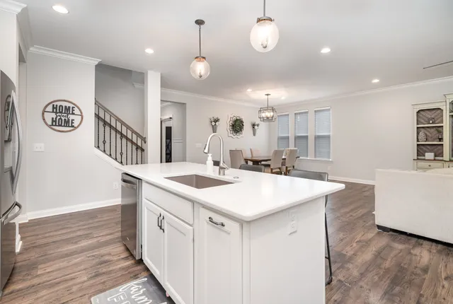 a kitchen with a sink and a stove top oven