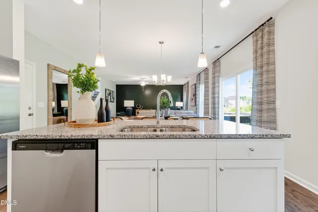 a kitchen with kitchen island granite countertop a table and chairs in it