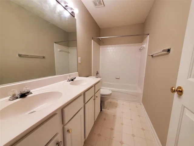 a kitchen with granite countertop a refrigerator stove and microwave