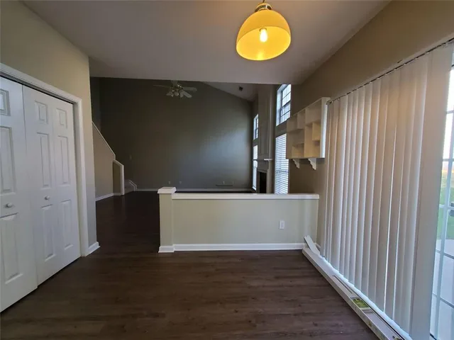 a view of an empty room with wooden floor