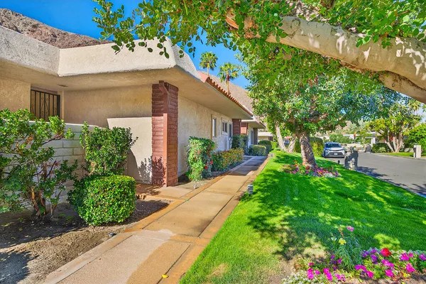 a front view of a house with a yard and a garage