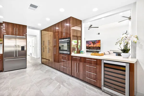 a kitchen with stainless steel appliances granite countertop a refrigerator and a sink