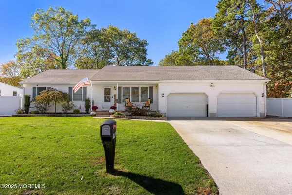 a front view of a house with yard patio and green space