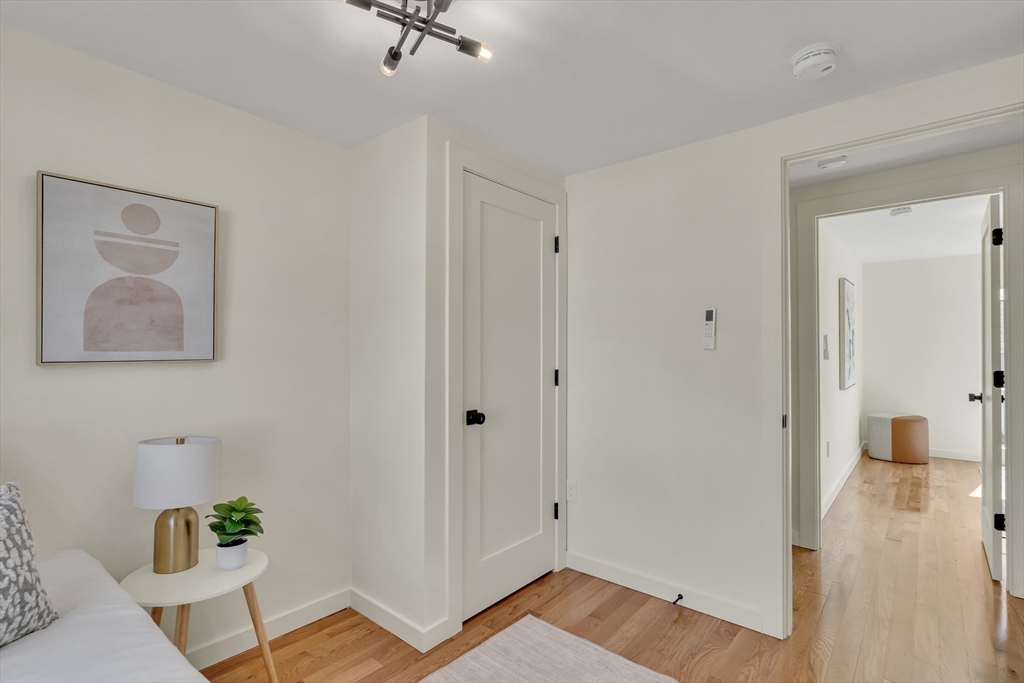 56 Riverview Street Dedham, MA 02026 - Photo 21 of 29 a view of a hallway with wooden floor and cabinet