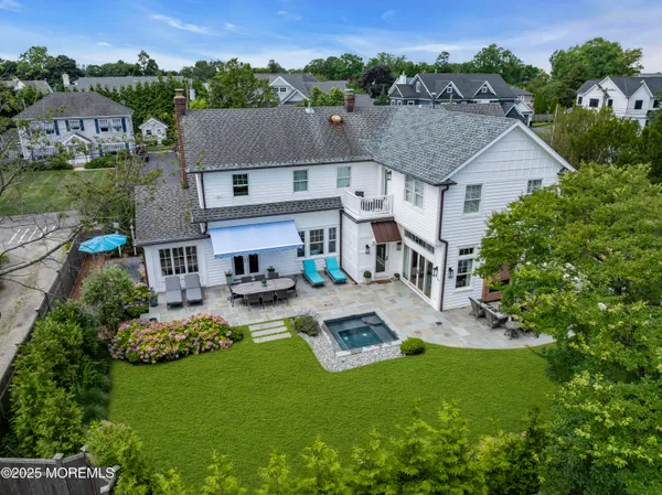 an aerial view of a house with swimming pool garden and patio