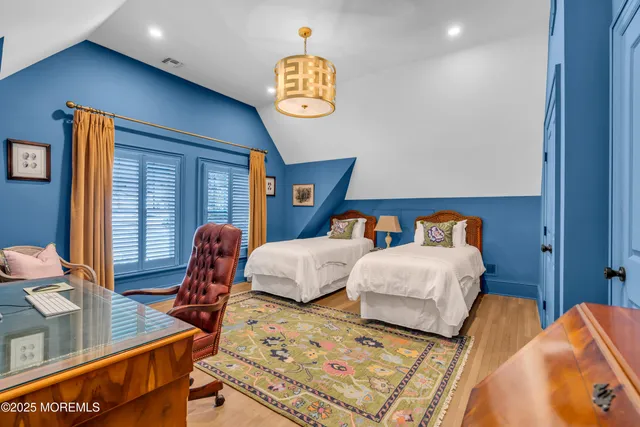 a bedroom with two beds and a chandelier