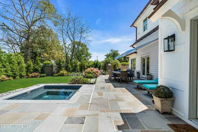 a view of a house with patio and a yard