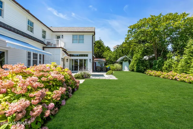 a house view with a sitting space and garden