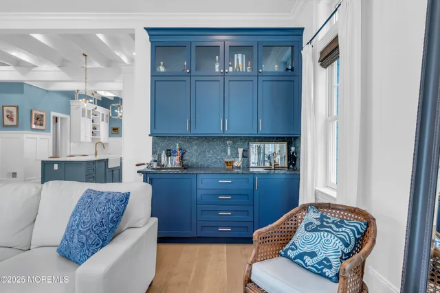 a view of a kitchen with kitchen island a stove a refrigerator a sink dishwasher with a dining table and chairs