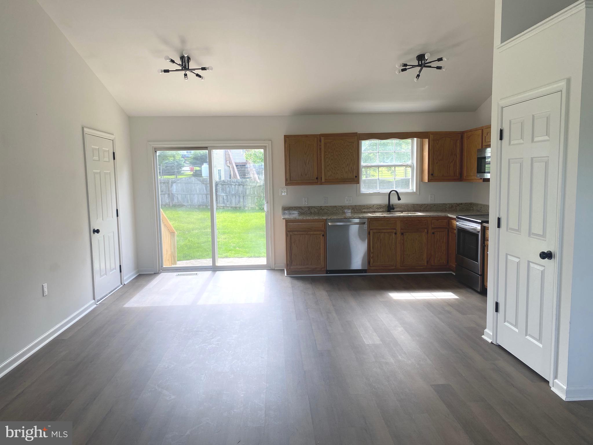 172 Jack Rabbit Lane Ranson, WV 25438 - Photo 11 of 34 a large kitchen with wooden floors and stainless steel appliances