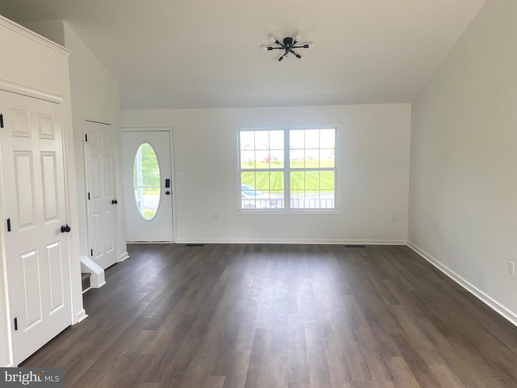 172 Jack Rabbit Lane Ranson, WV 25438 - Photo 12 of 34 an empty room with wooden floor and windows